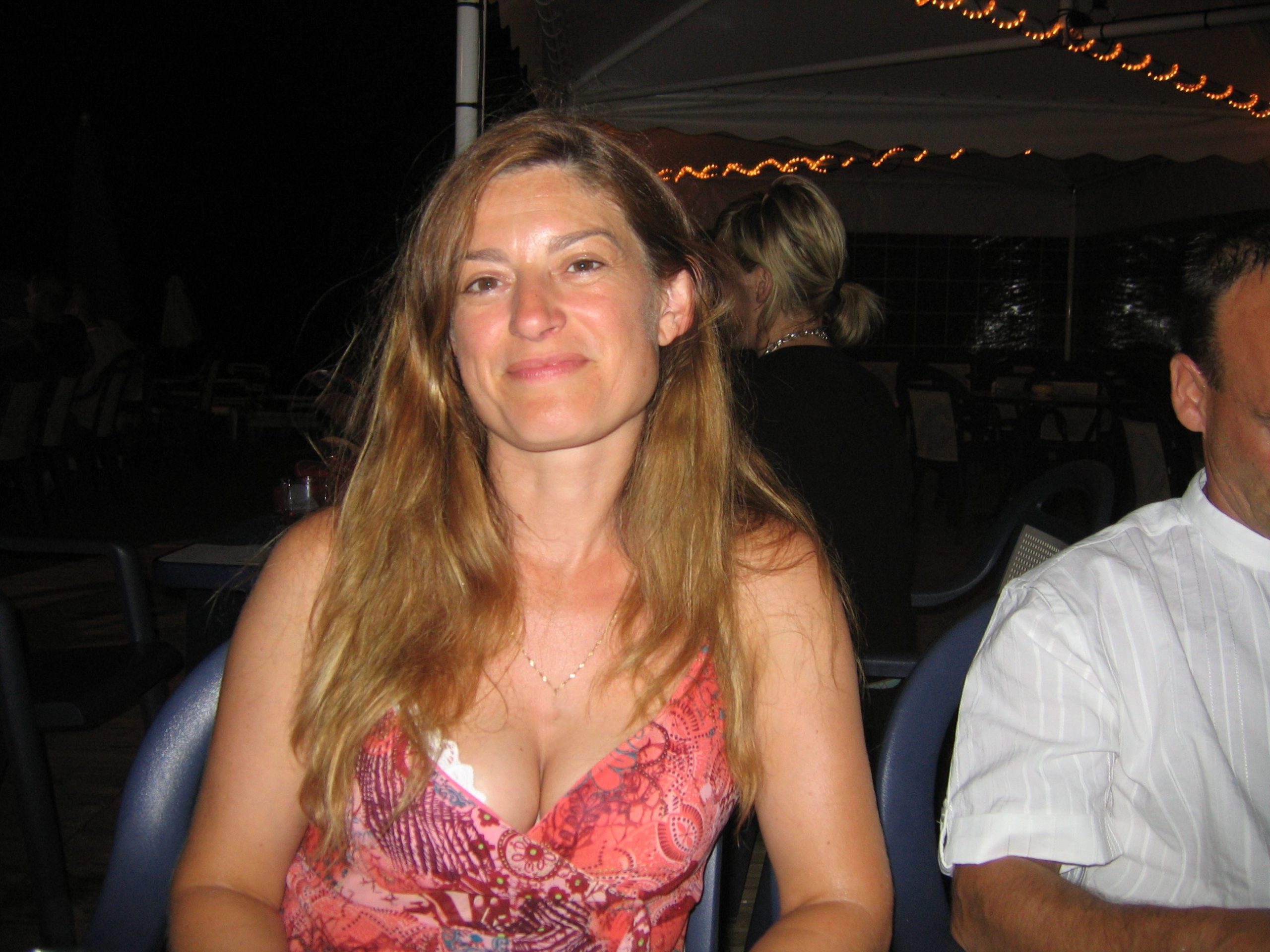 MeetLocalMILFs.Online - MILF Dating Site - Cute MILF Wife With Nice Breasts Posing For Camera At Beach Bar.